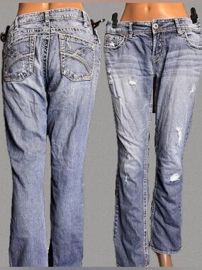 Silver blue jeans with white stitching and distressing
